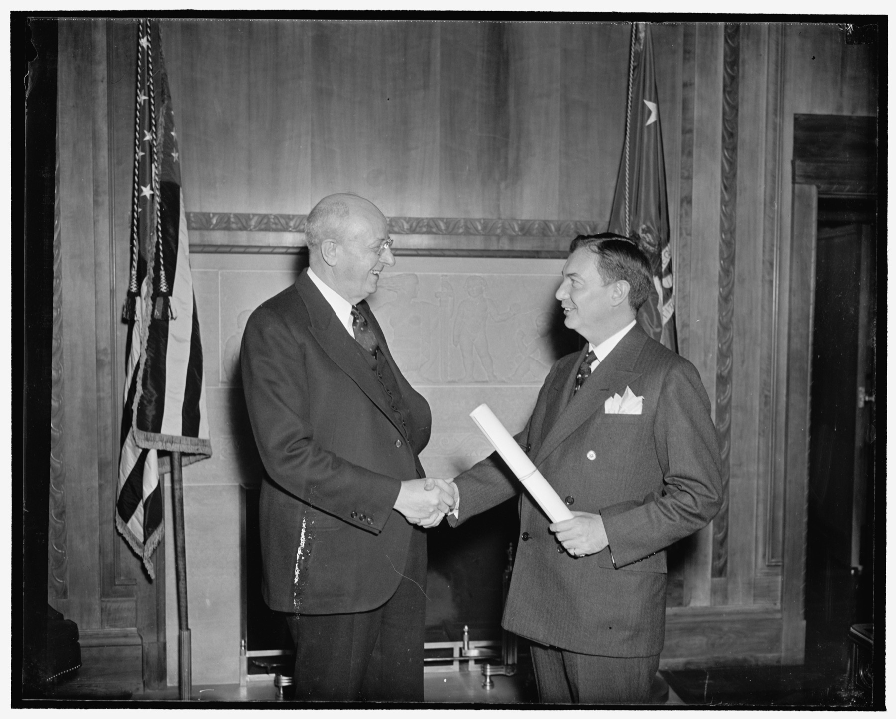 Attorney General Homer Cummings congratulating Robert H. Jackson after Jackson was sworn in as Solicitor General.
