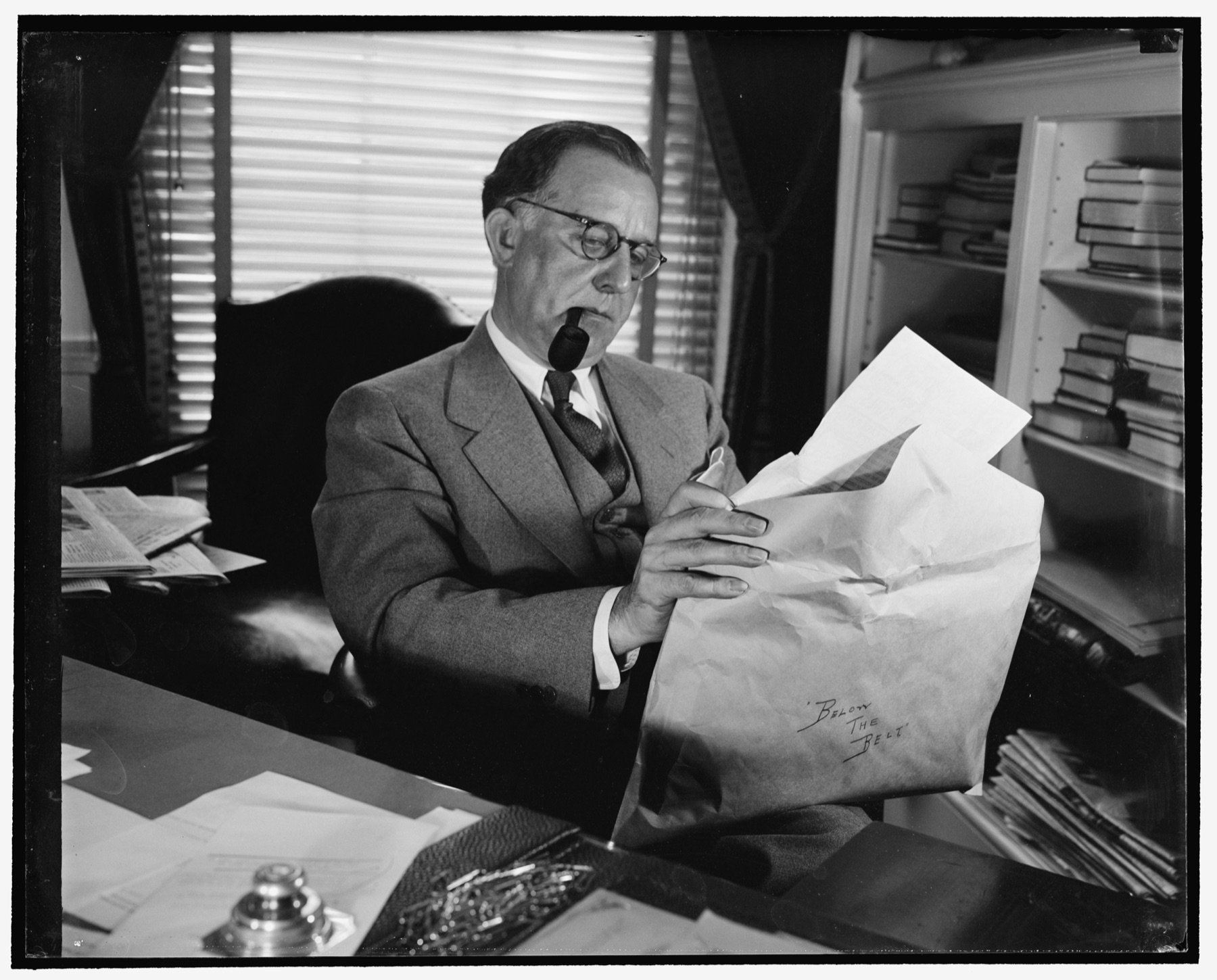 Stephen T. Early, President Roosevelt's press secretary, at his desk in the White House.