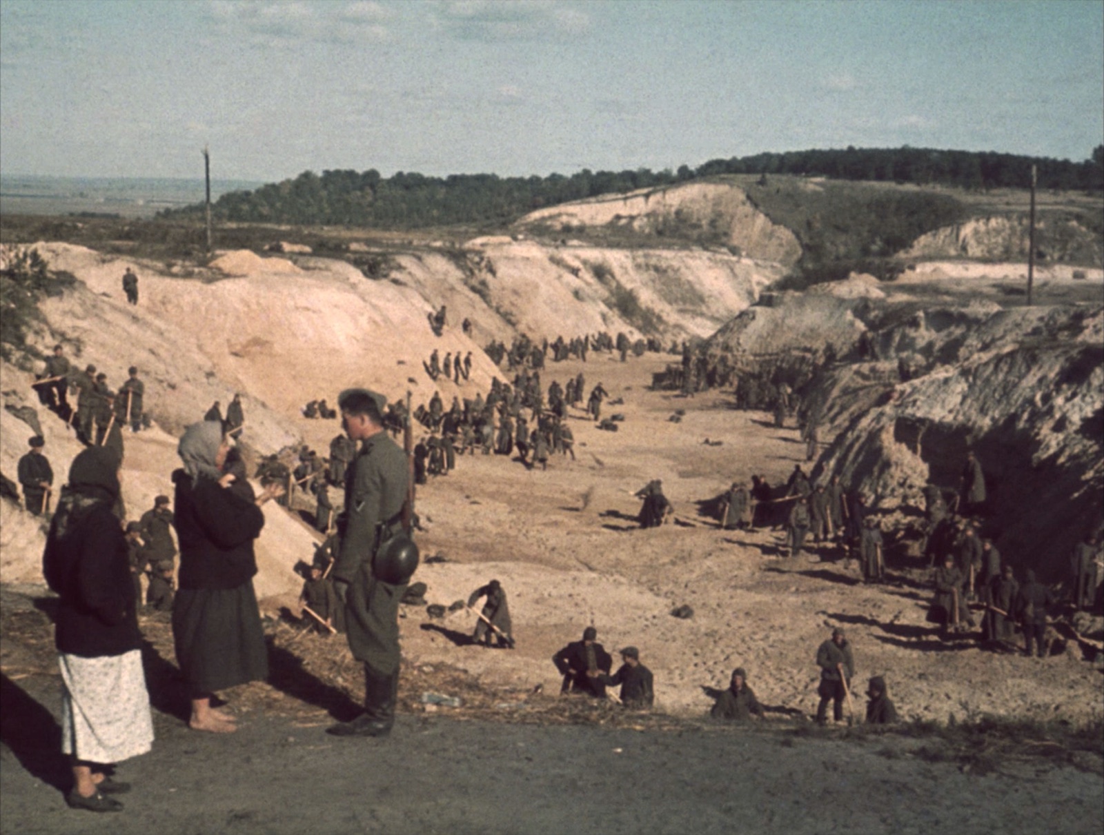 Soviet prisoners of war shoveling earth over a mass grave at Babyn Yar after the massacre.