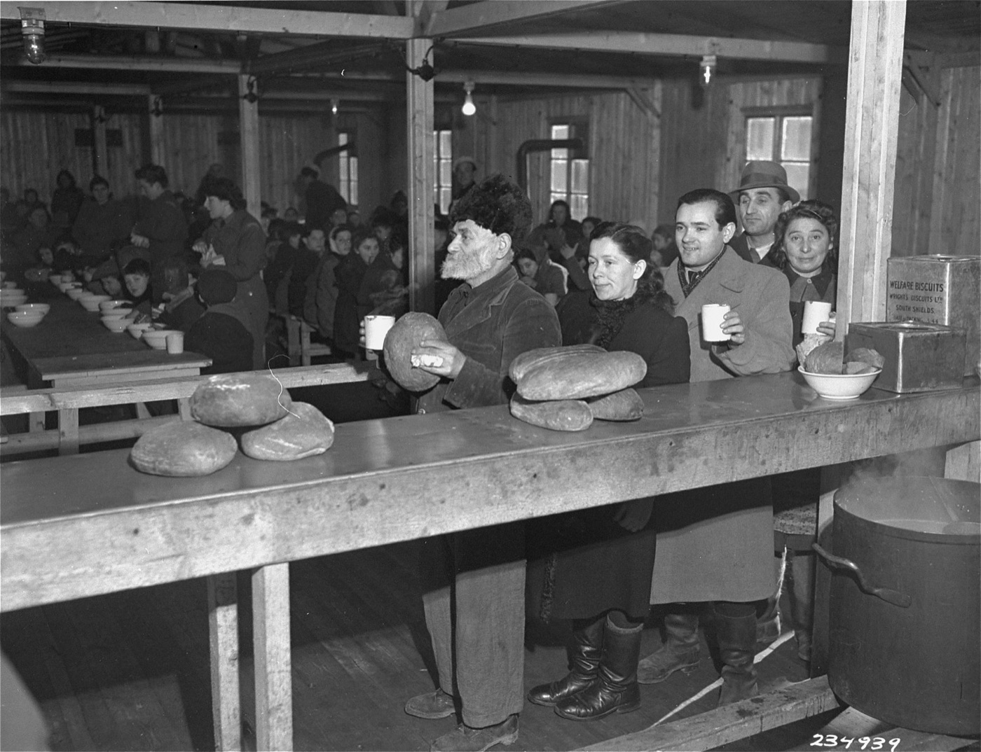 Jewish displaced persons lining up to receive bread rations at a displaced persons camp in Linz.
