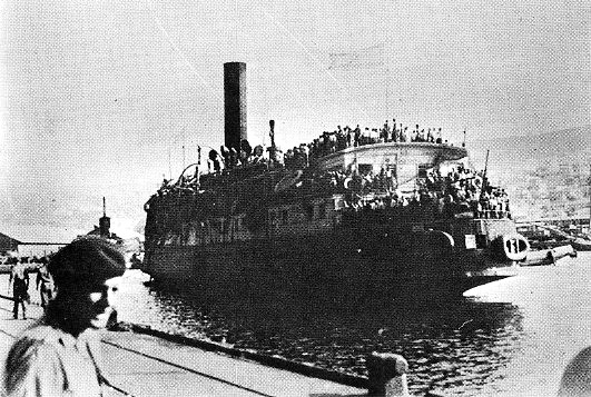 The refugee ship Exodus 1947 arriving in Haifa harbor crowded with people.