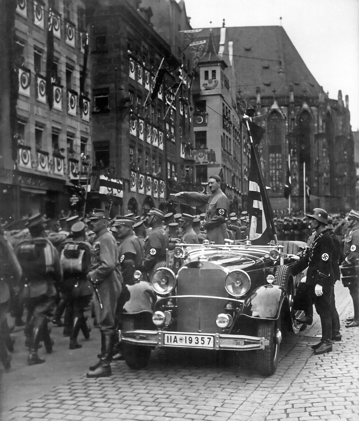 Ranks of SA men marching past Adolf Hitler at the Nuremberg party rally in September 1935.