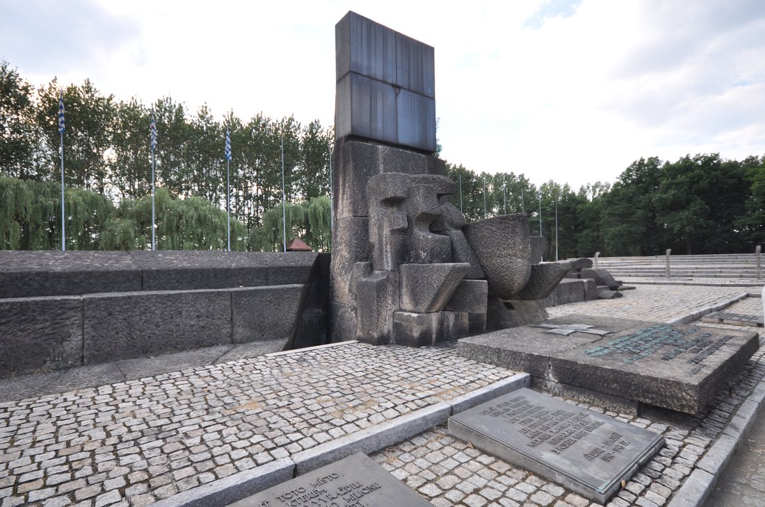 The stone memorial monument at Birkenau under an overcast sky