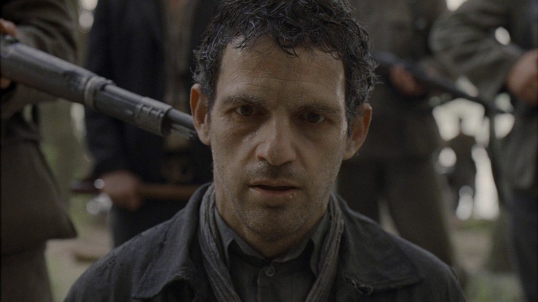 Extreme close up of a man's face in shallow focus, everything behind him blurred