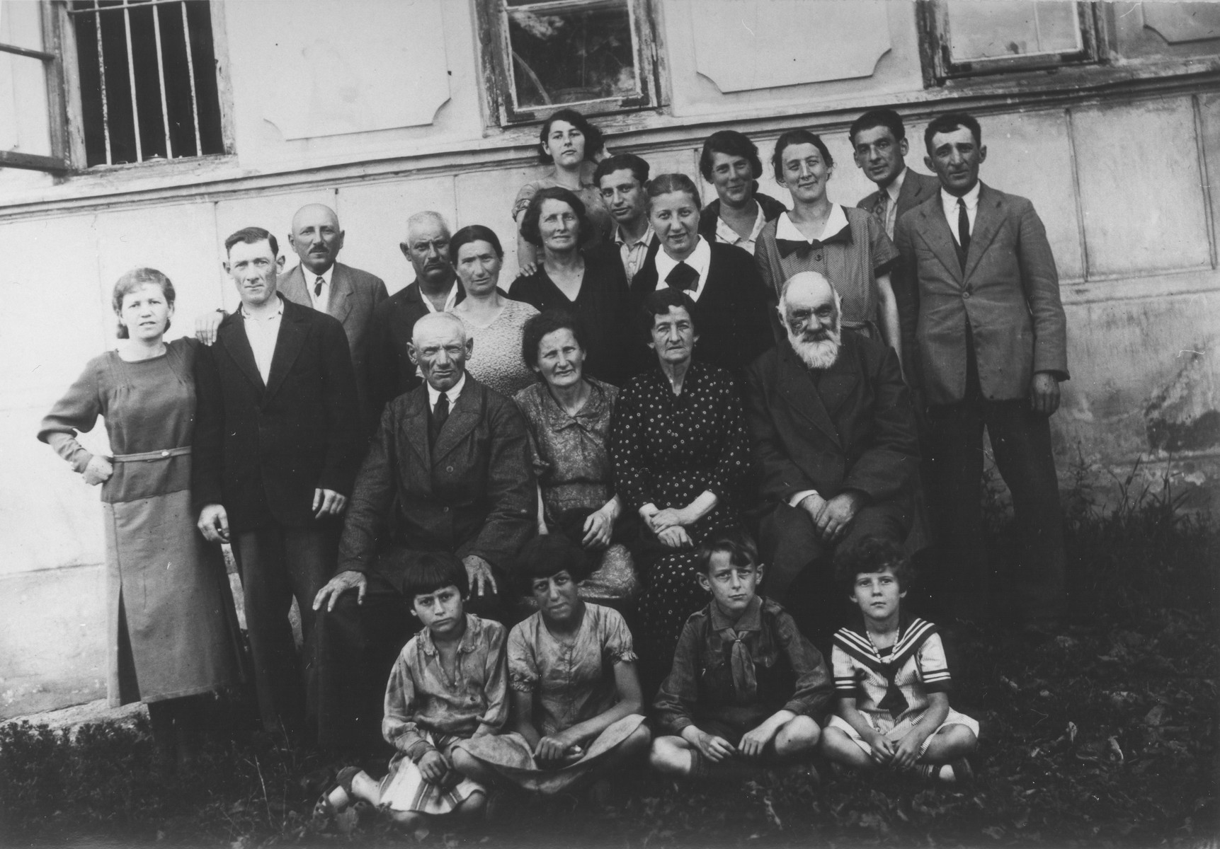 A three-generation Jewish family of Piotrk&oacute;w Trybunalski, Poland, posed outside their home, c.1935.