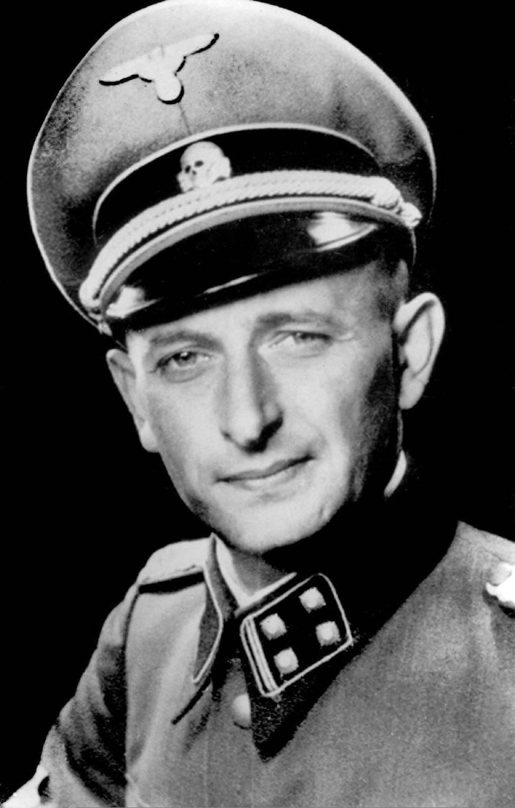 Head-and-shoulders official photograph of a man in SS uniform with a peaked cap, facing the camera.
