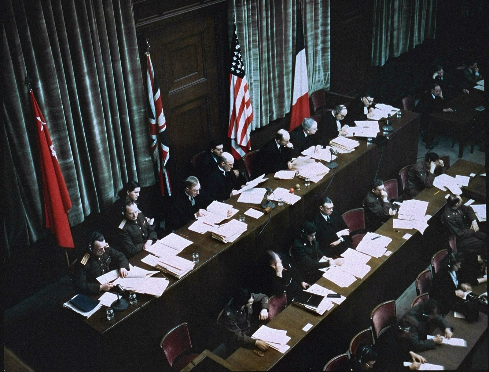 Eight judges in dark robes and suits seated along a raised bench in a wood-paneled courtroom, photographed in color.